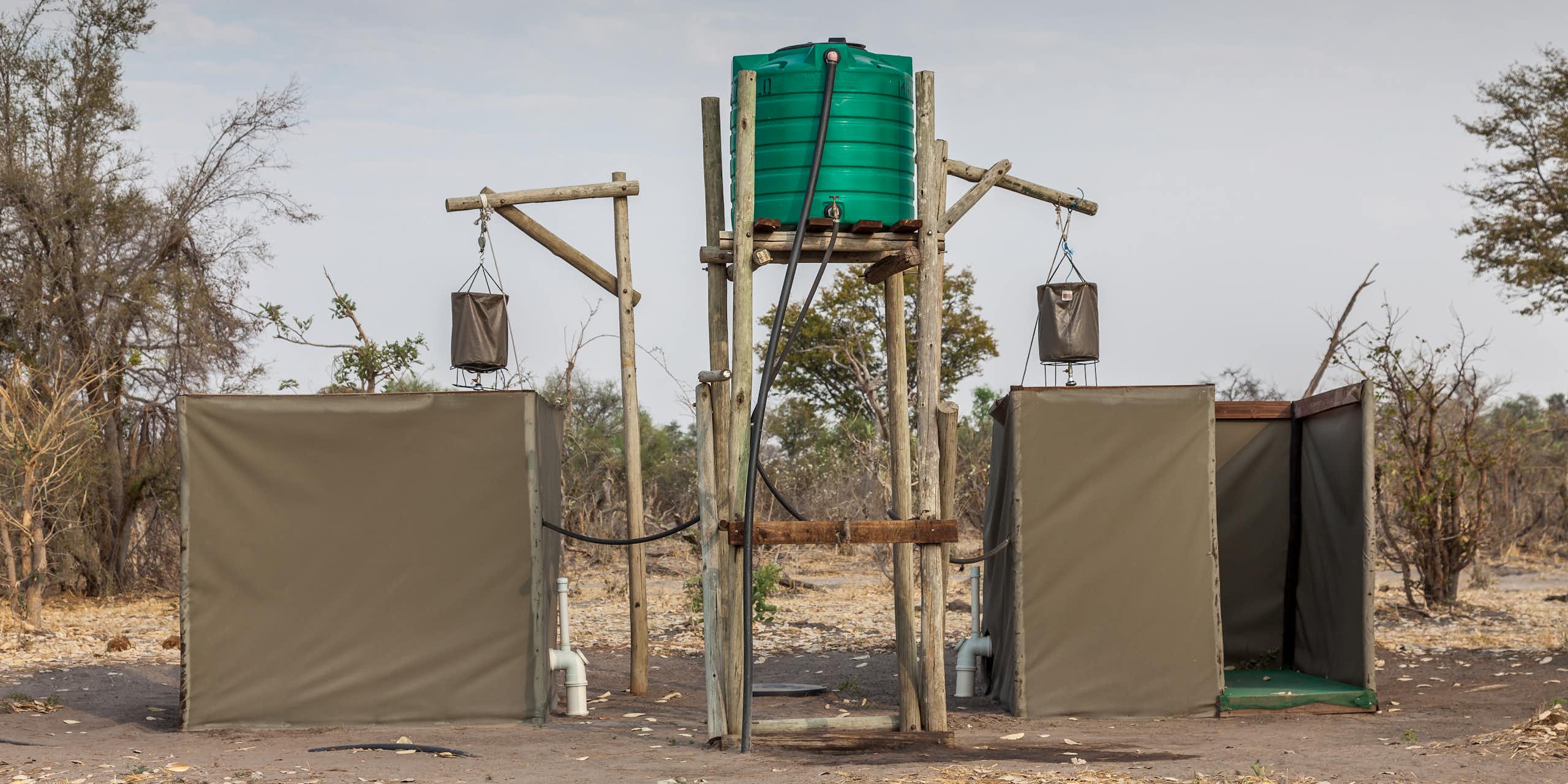 Eco-friendly outdoor showers with a bucket hung up high and linked to a water tank