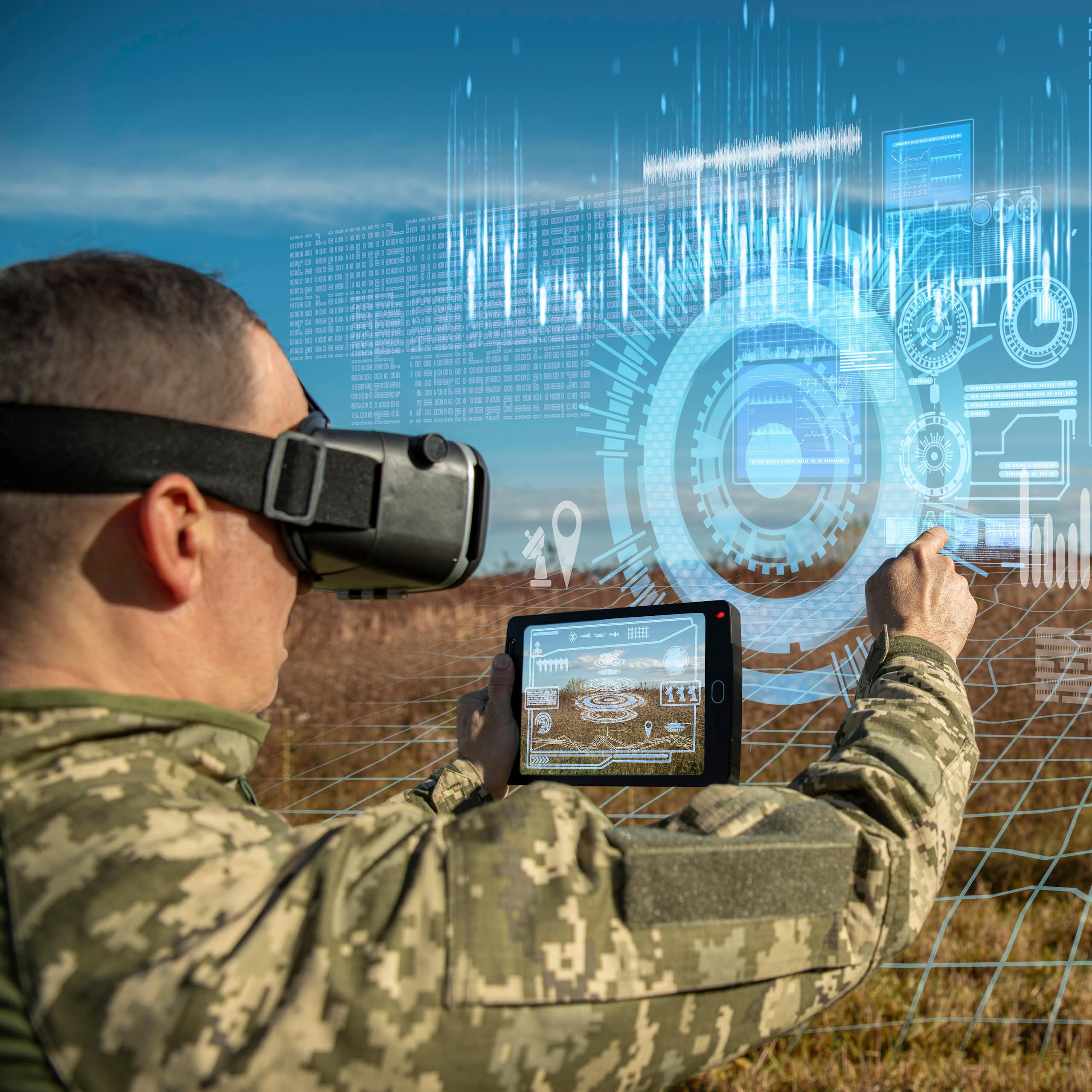 Warfare analytic operator using virtual reality glasses checking coordination of the military team with tablet device augmented device.