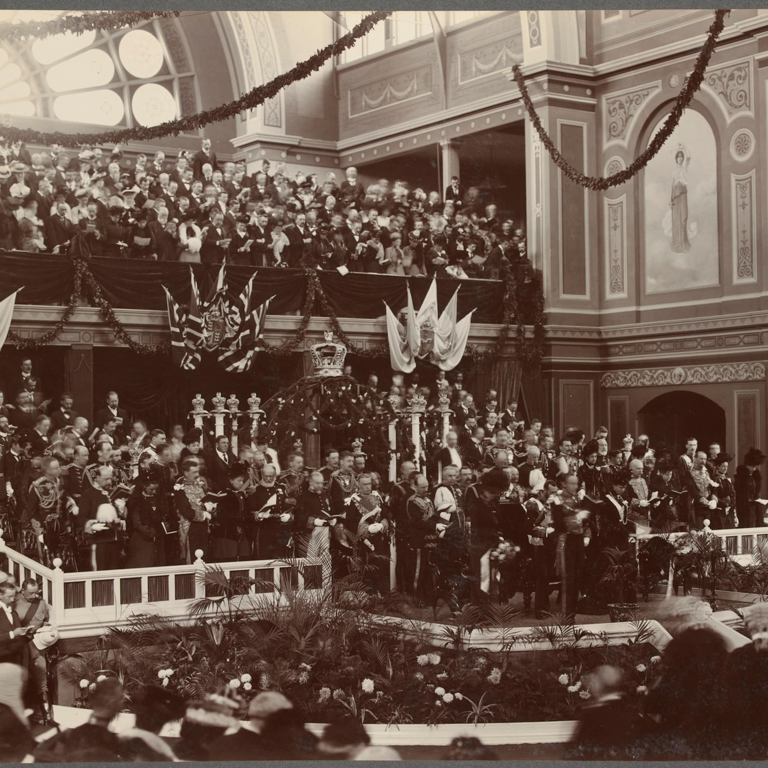 A large crowd of men in suits in an ornate room