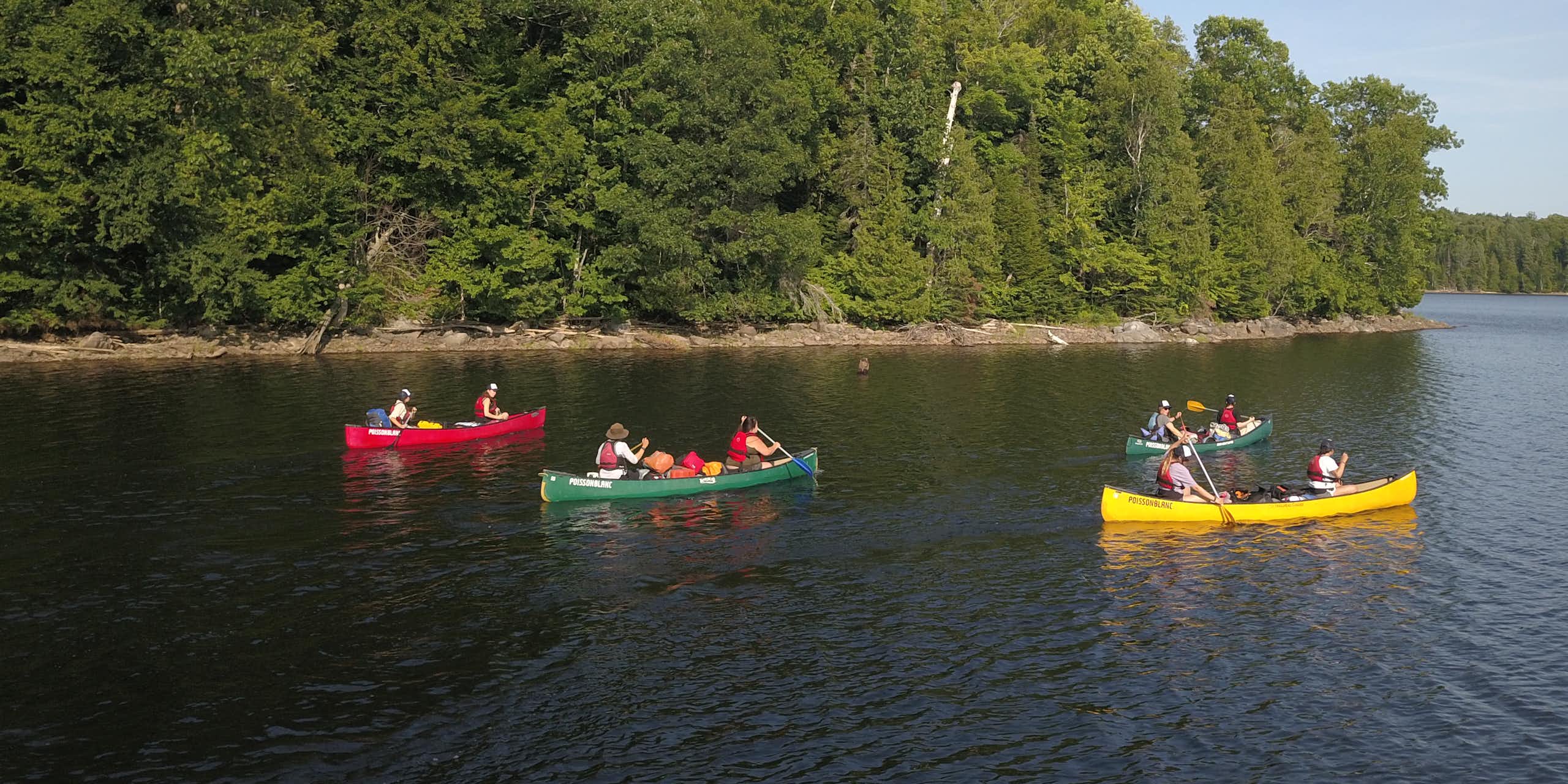People seen in canoes on the water.