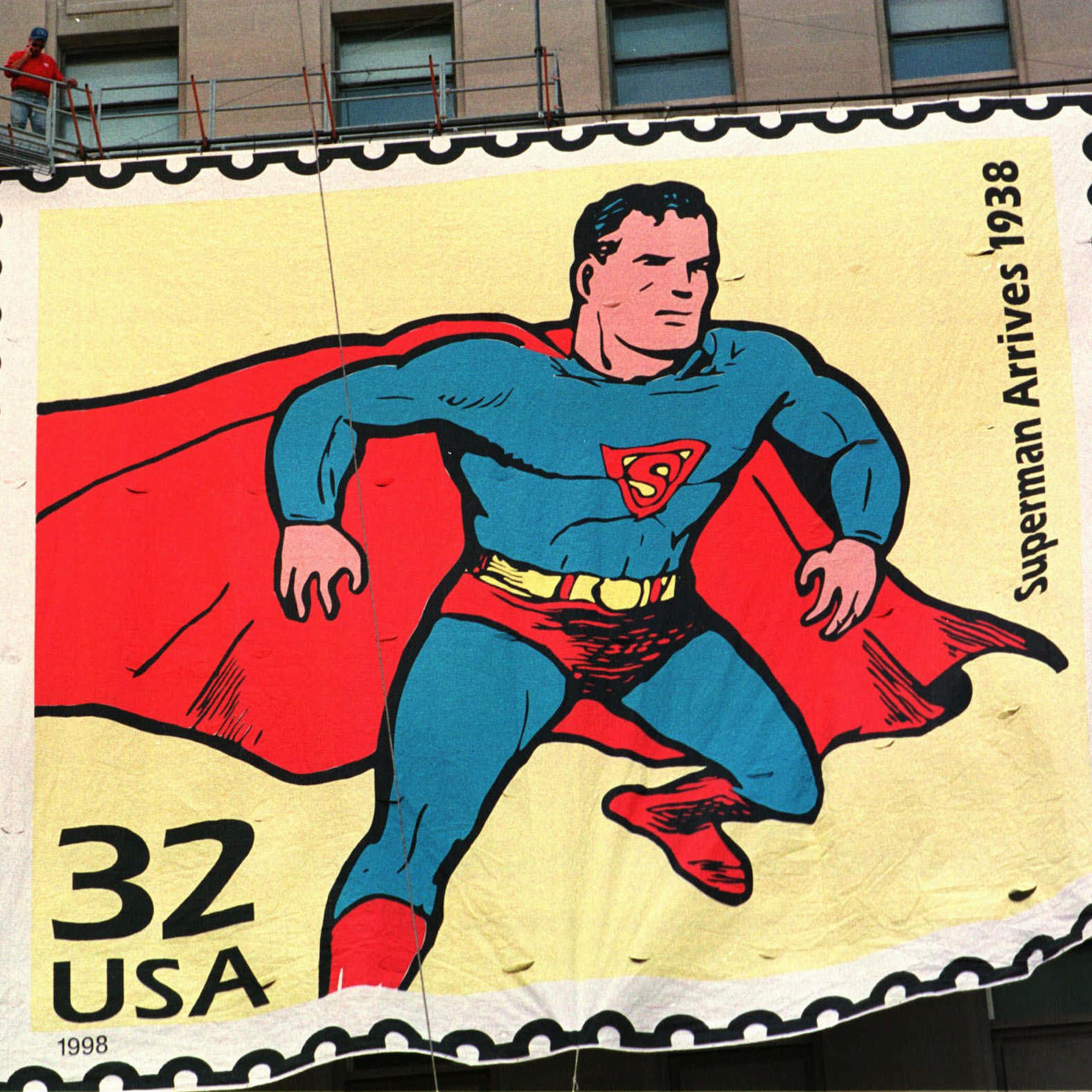 A large sign depicts a man in a tight blue suit and red cape.