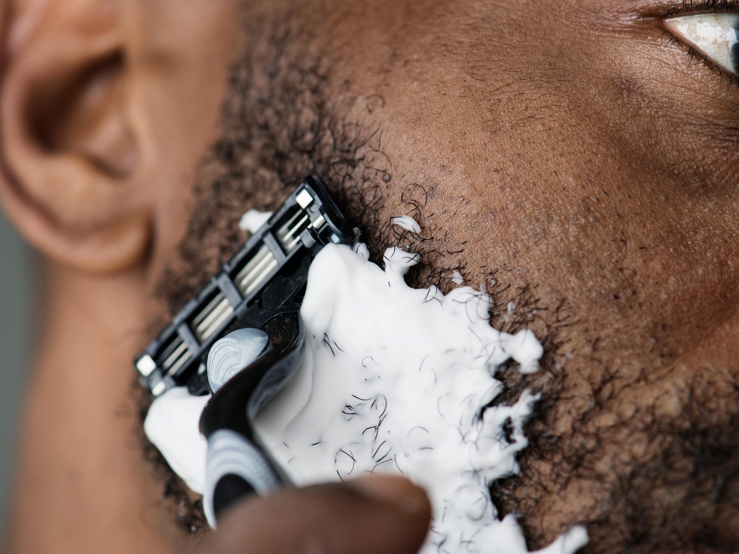 A man shaving his beard 