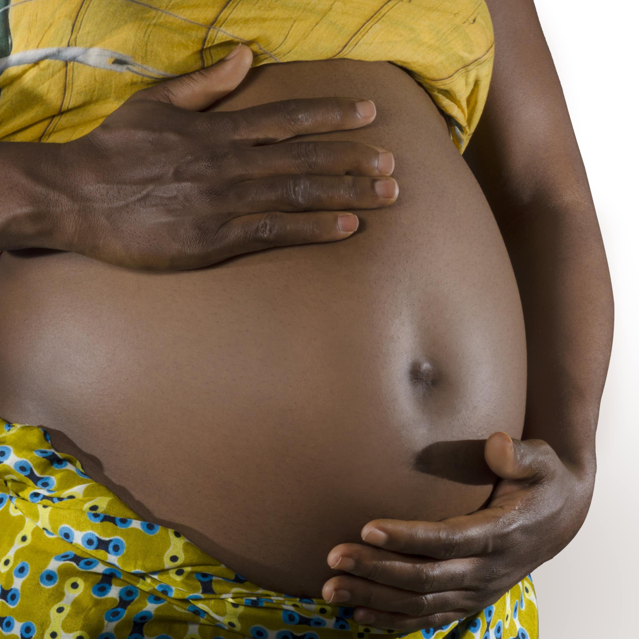 A pregnant woman holding her belly