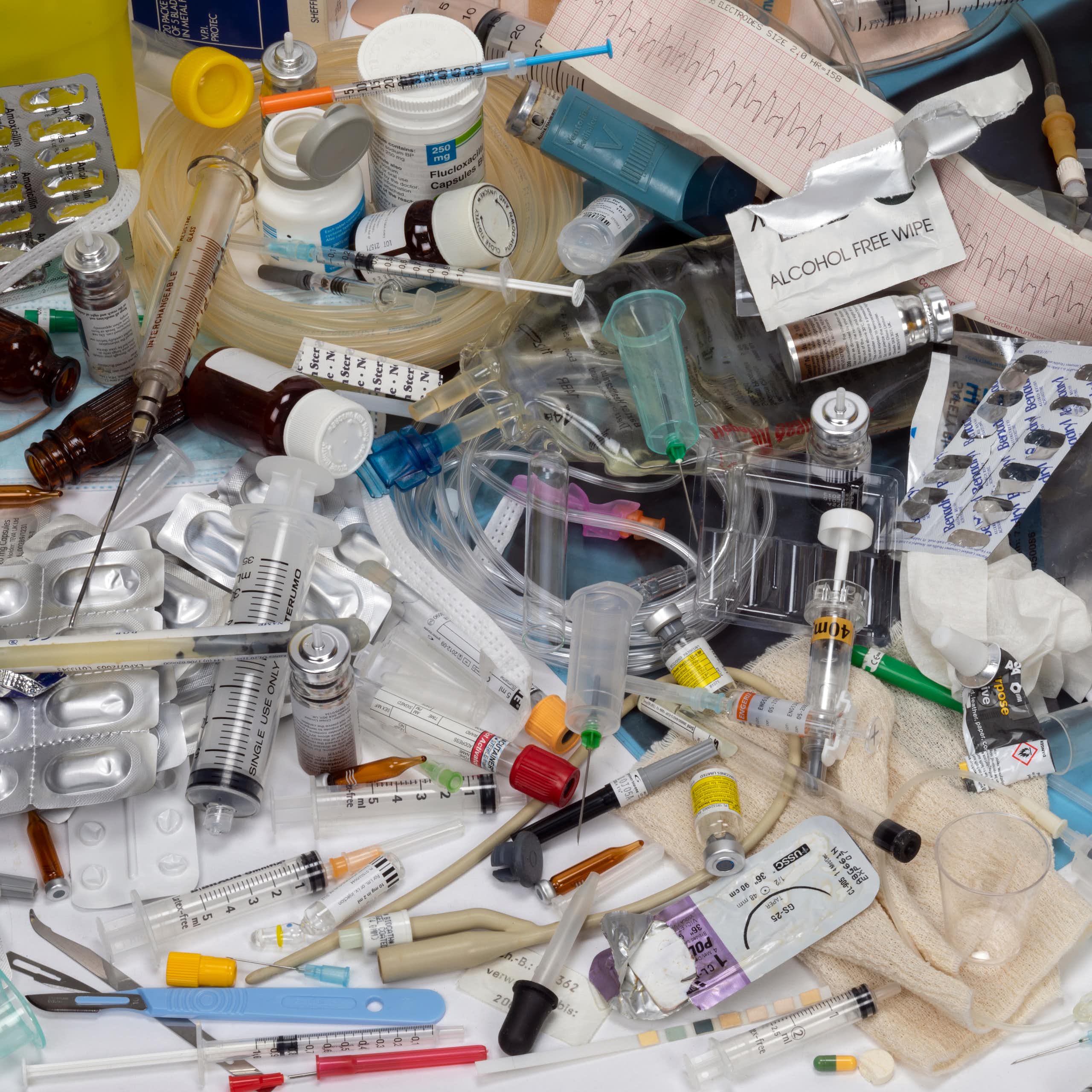A collection of used, single-use medical plastic items — such as syringes, wipes, medicine containers and gloves.
