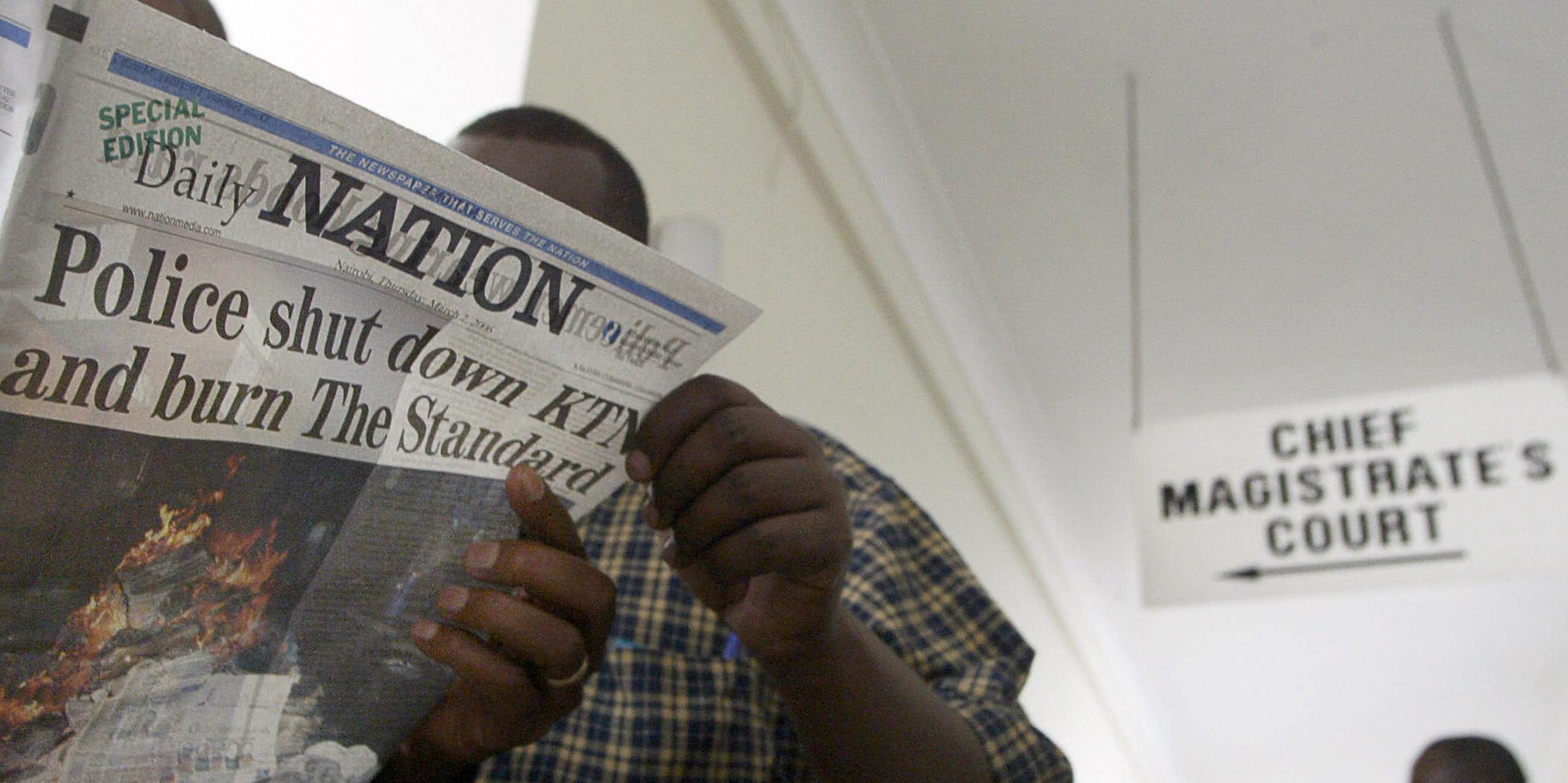 A man holding a newspaper