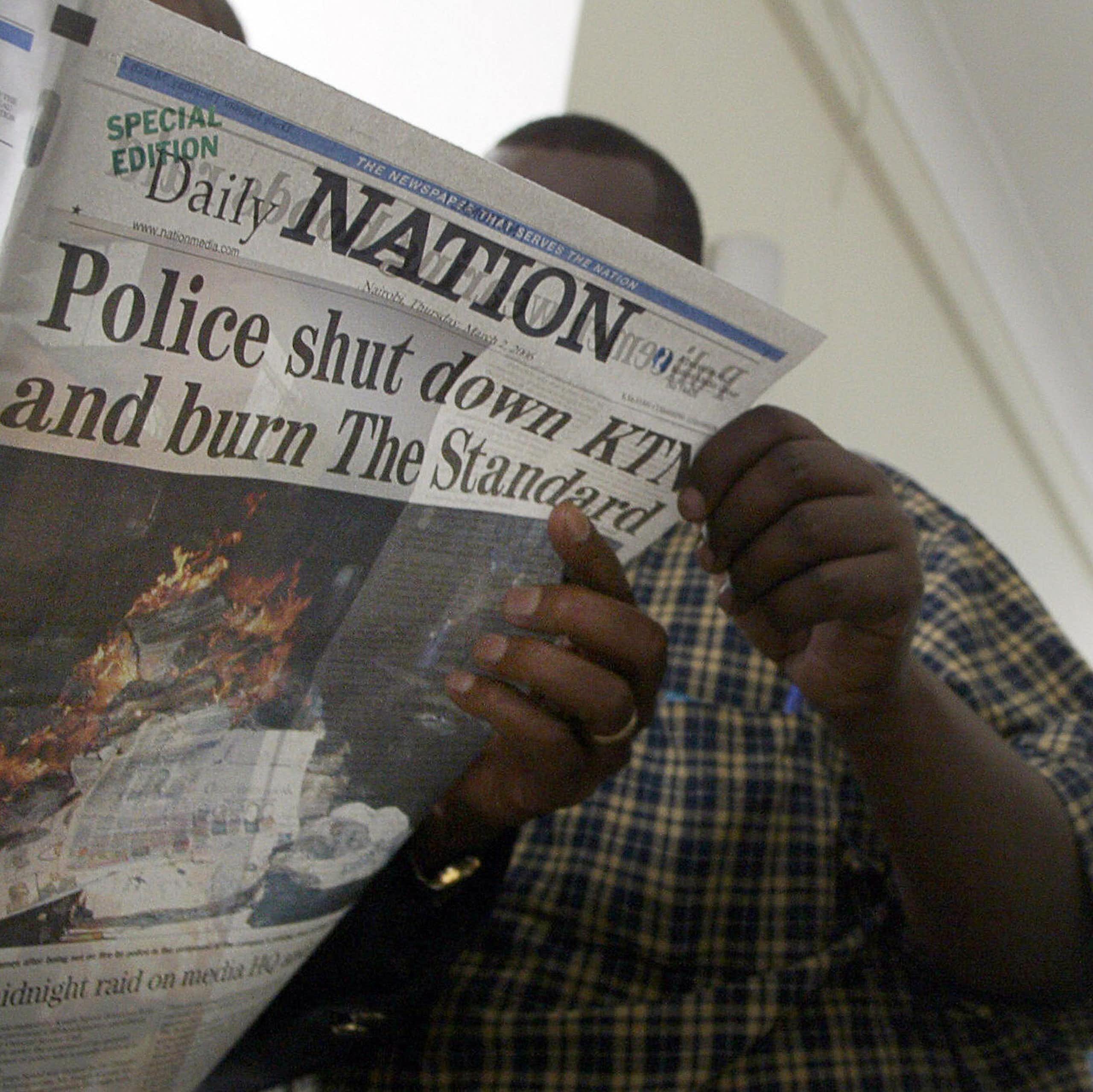 A man holding a newspaper