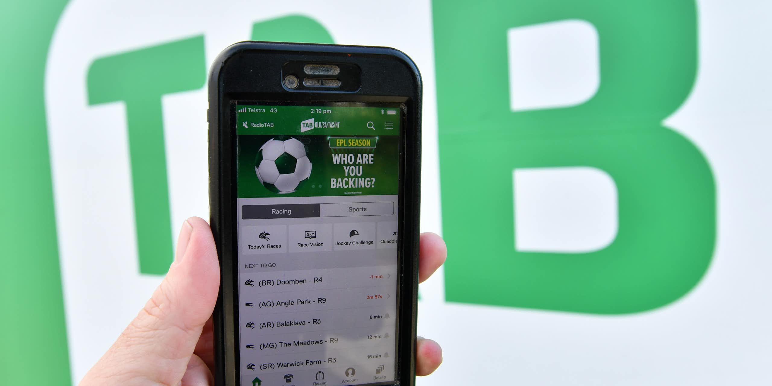 The TAB betting app is seen on a mobile phone outside a Tabcorp venue