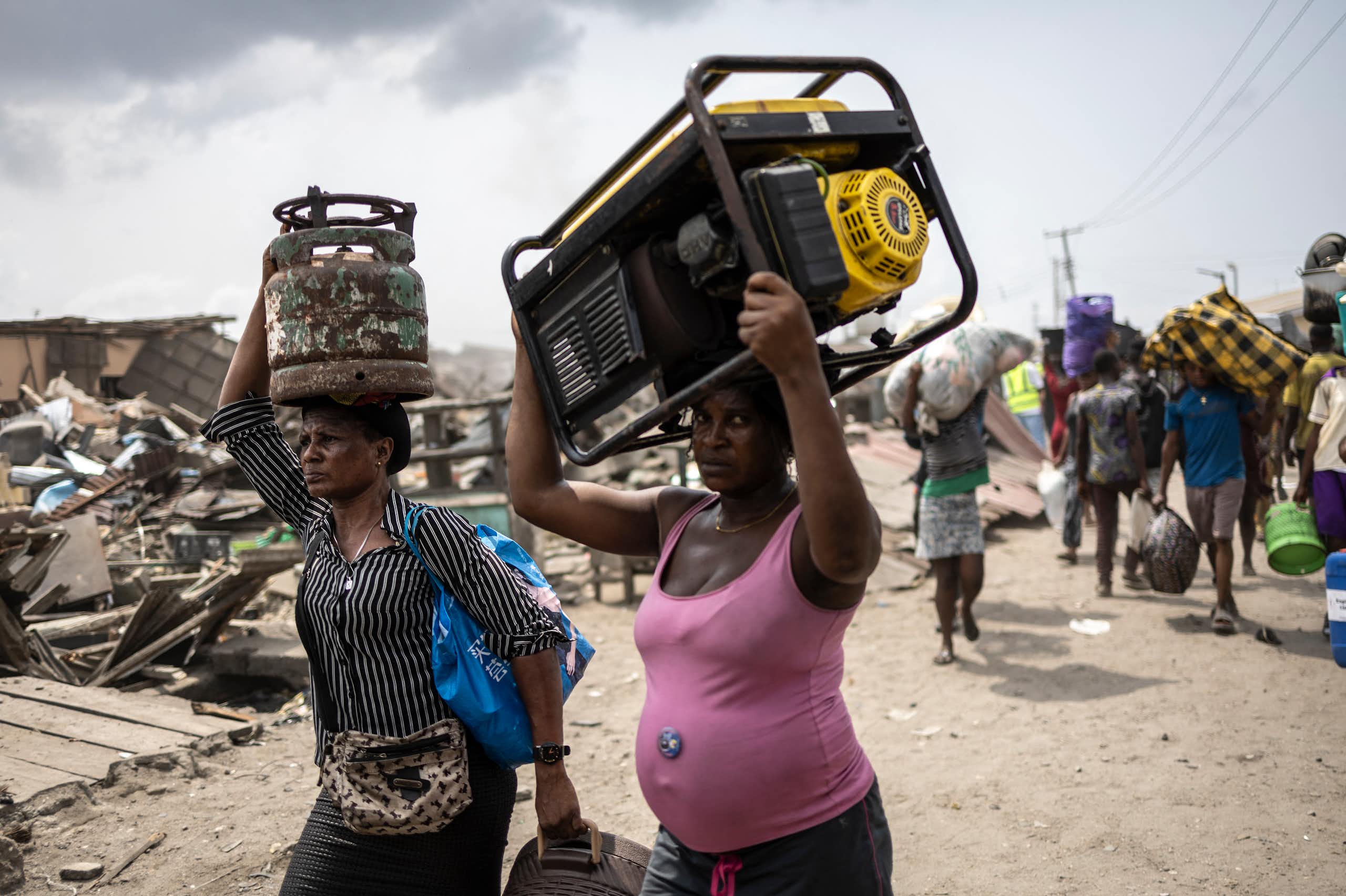 Women carrying household items on their head
