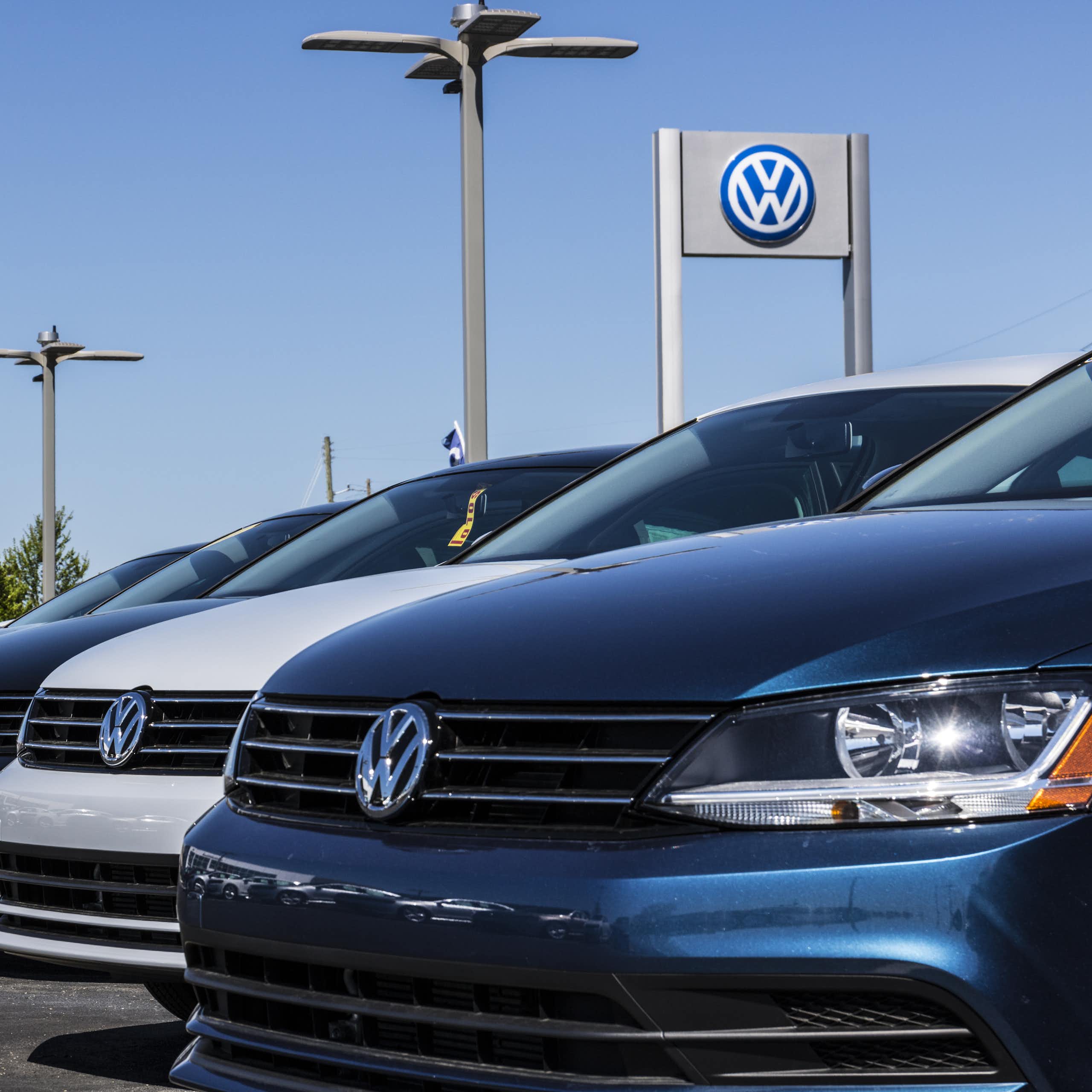 brand new cars lined up at a volkswagen dealership