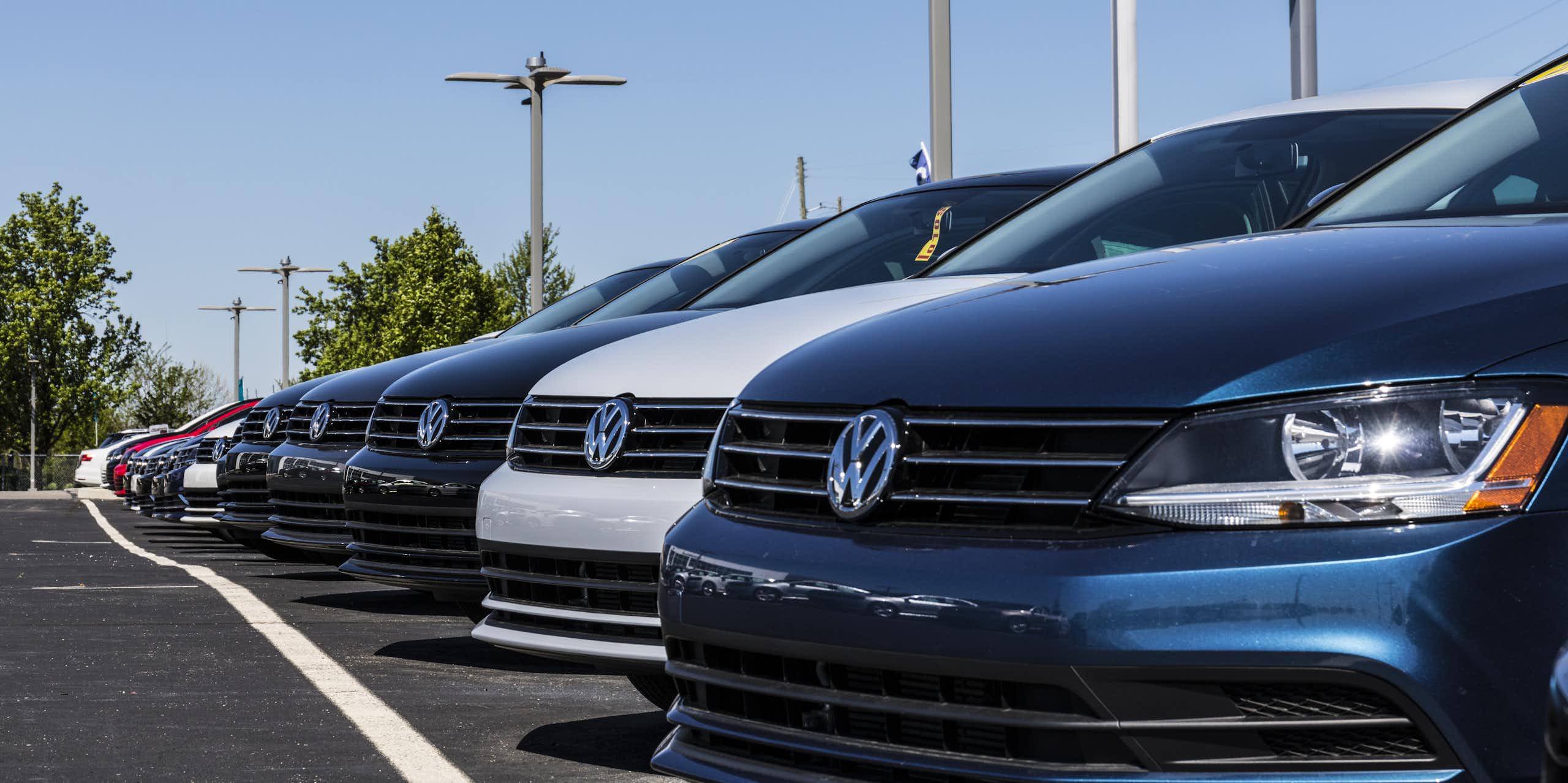 brand new cars lined up at a volkswagen dealership