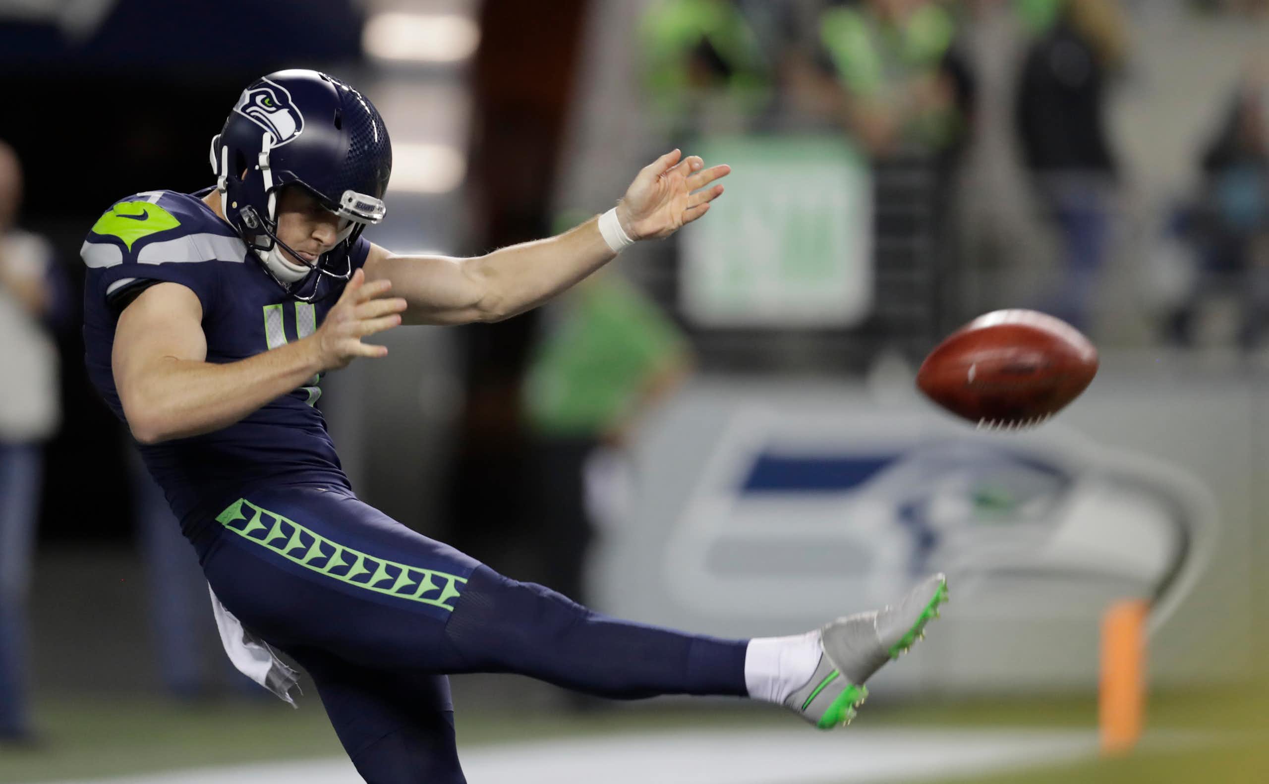 Michael Dickson punts the ball during a 2024 NFL game.
