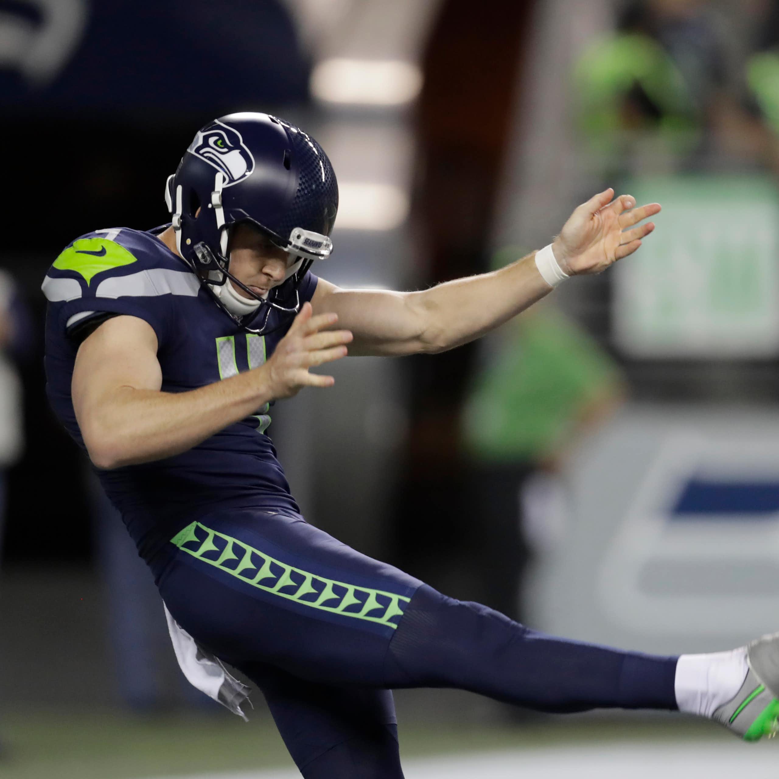 Michael Dickson punts the ball during a 2024 NFL game.