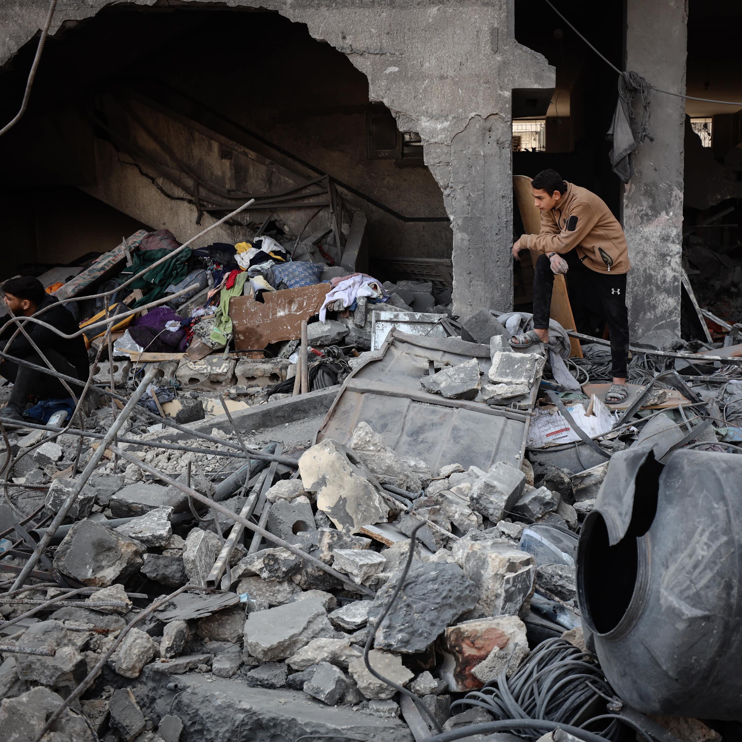A man surveys rubble and debris.