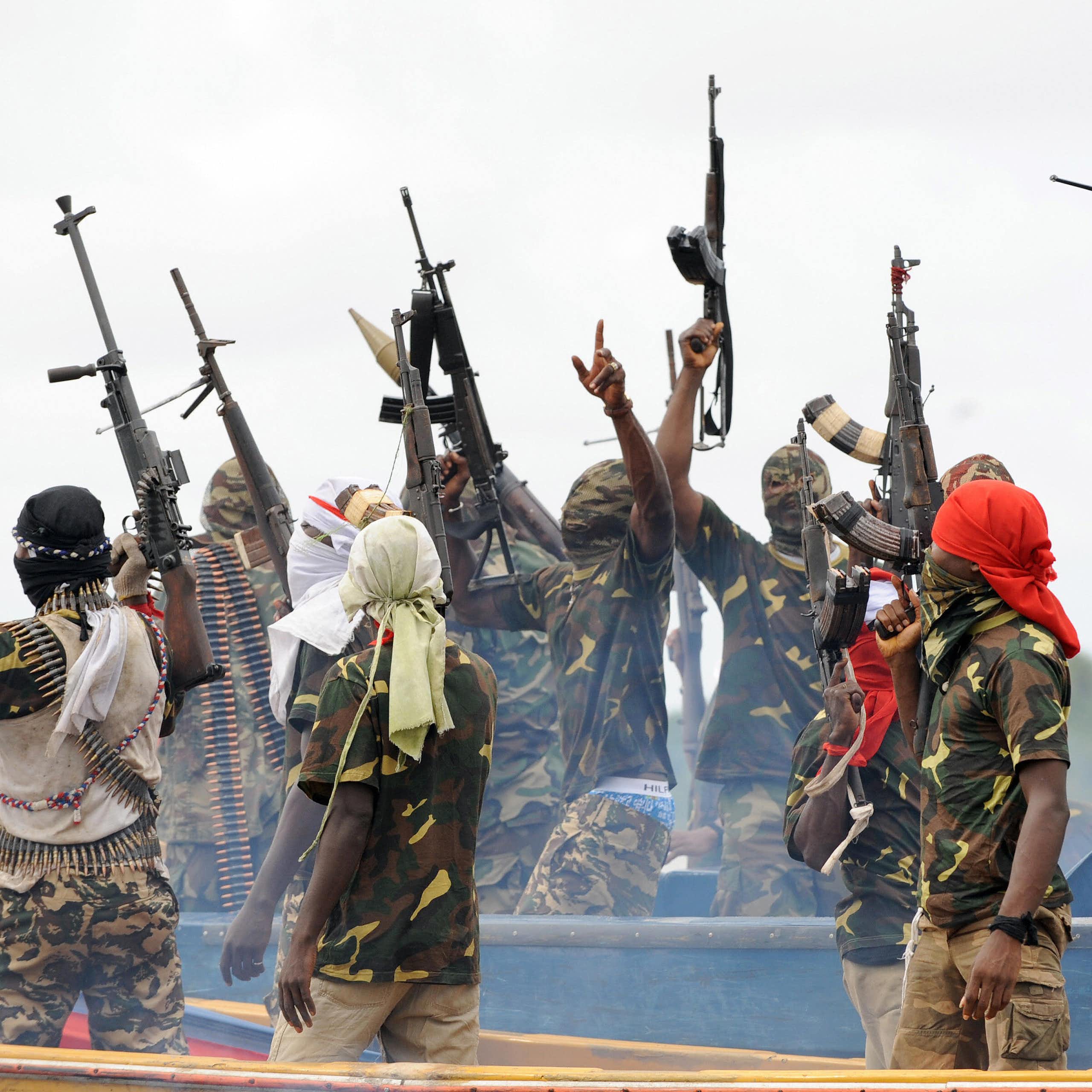 Men waving their rifles in the air in celebration