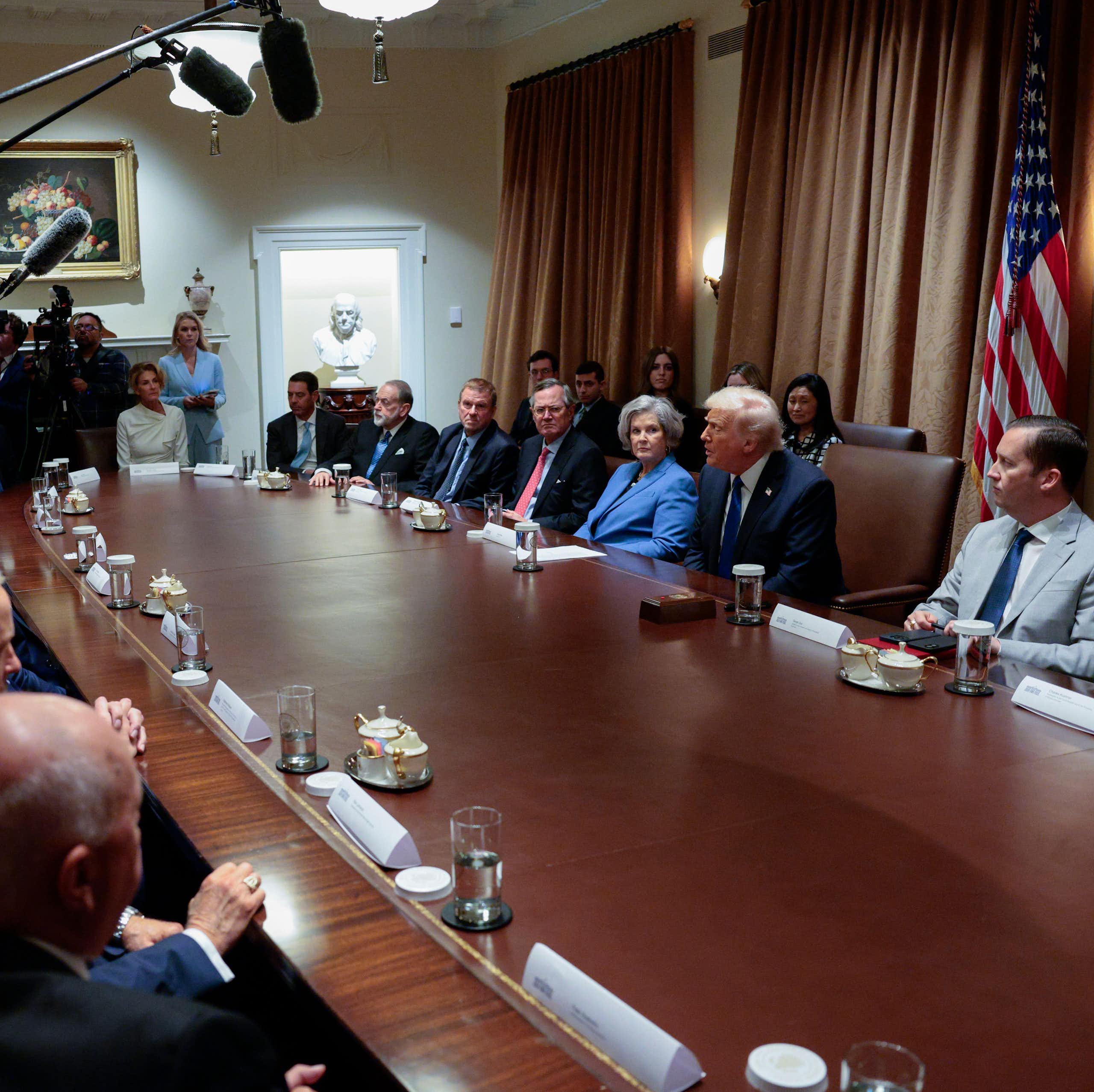 US president Donald Trump sits in the cabinet room in the White House next to his chief of staff, Susie Wils, and a group of senior officials.