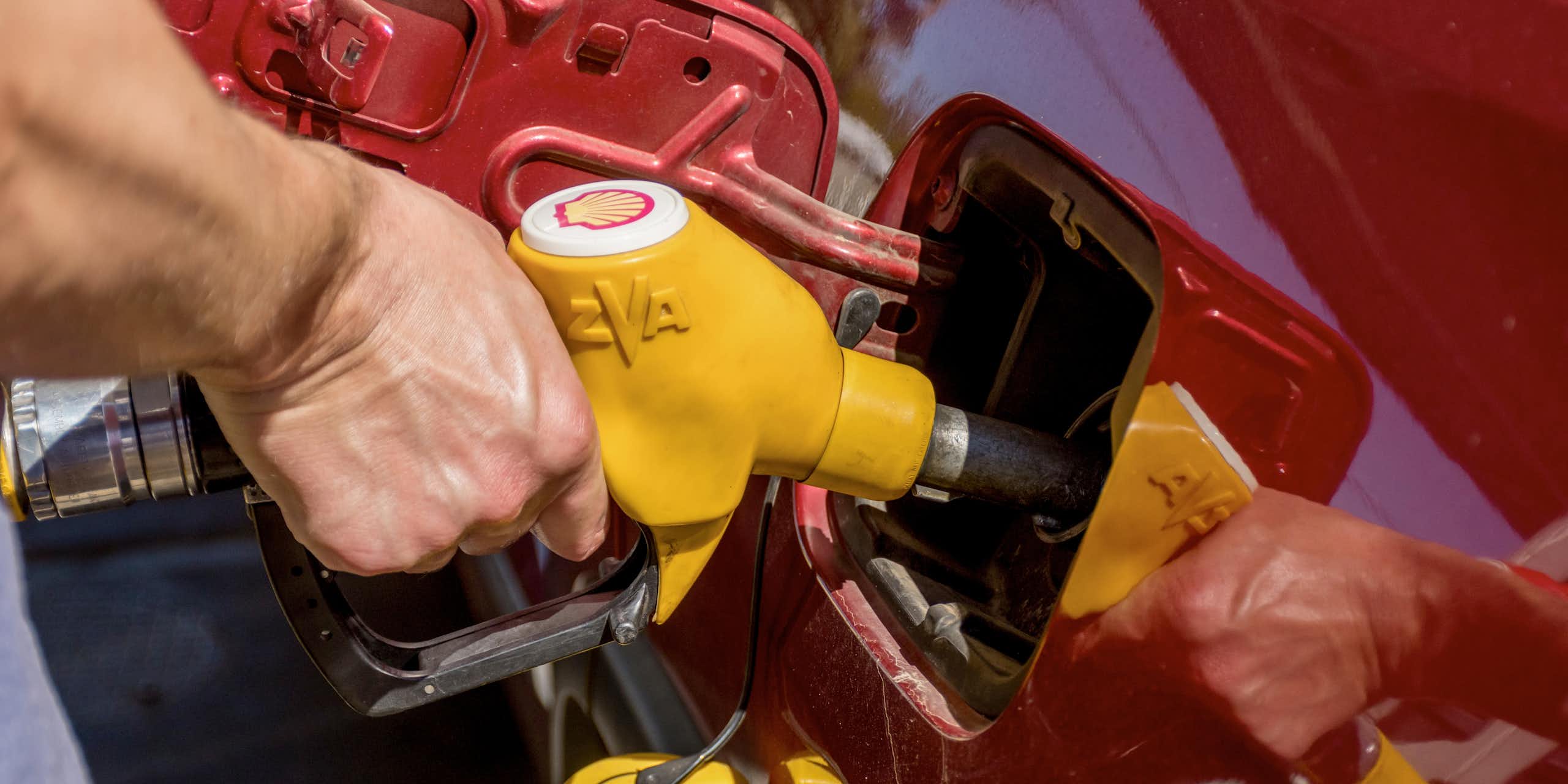 Person filling car up with fuel