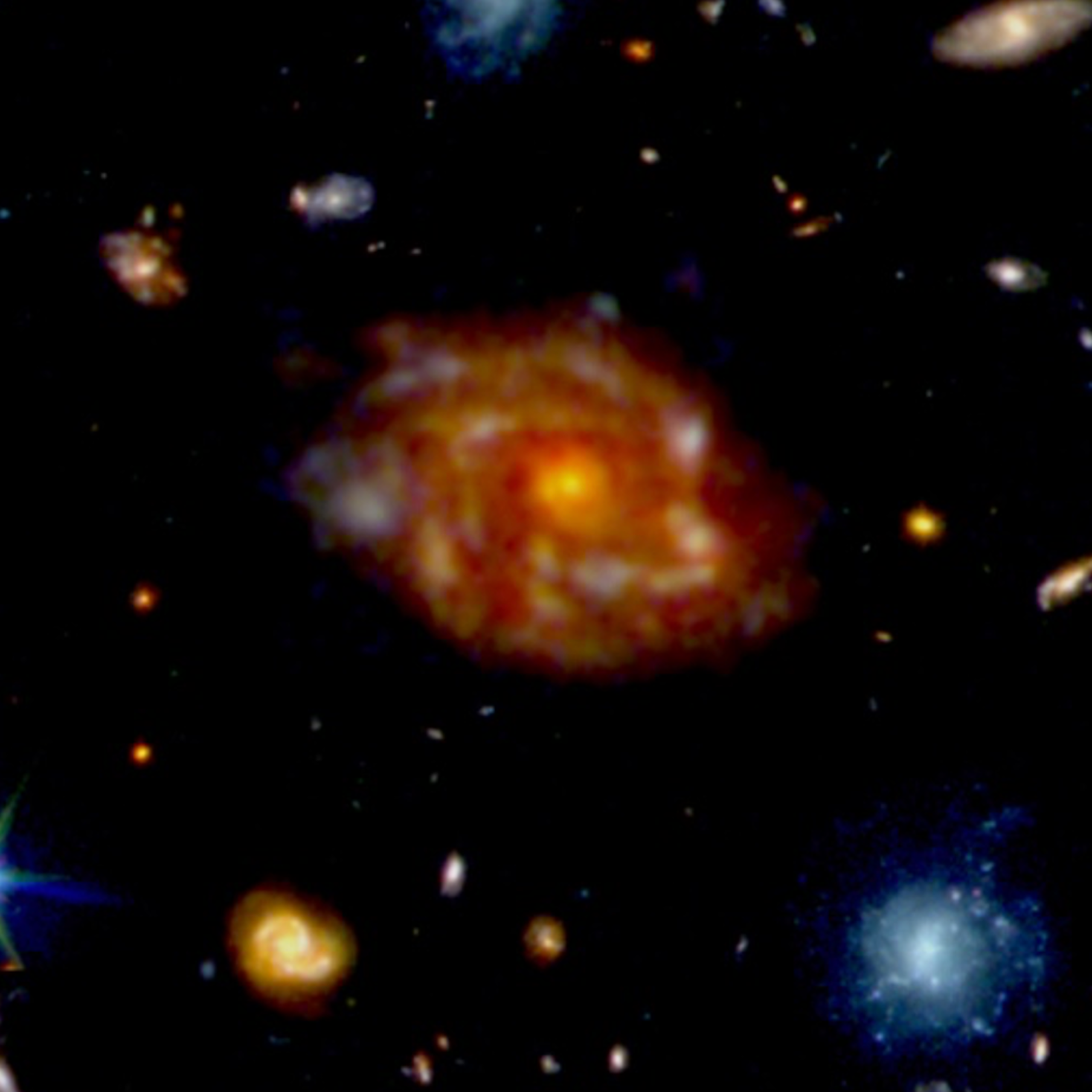 A large orange galaxy with spiral arms and smaller galaxies around it.